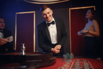 A cheerful woman in traditional clothing using her smartphone during a festive moment, showing how easily the GGGJL app fits into everyday life.