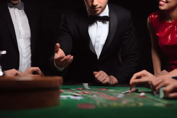 A glowing roulette wheel with cascading chips, symbolizing the engaging live and instant-win games available on GGGJL.